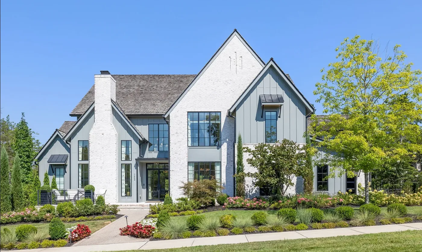 White modern farmhouse as it appears in its online listing photo, daytime